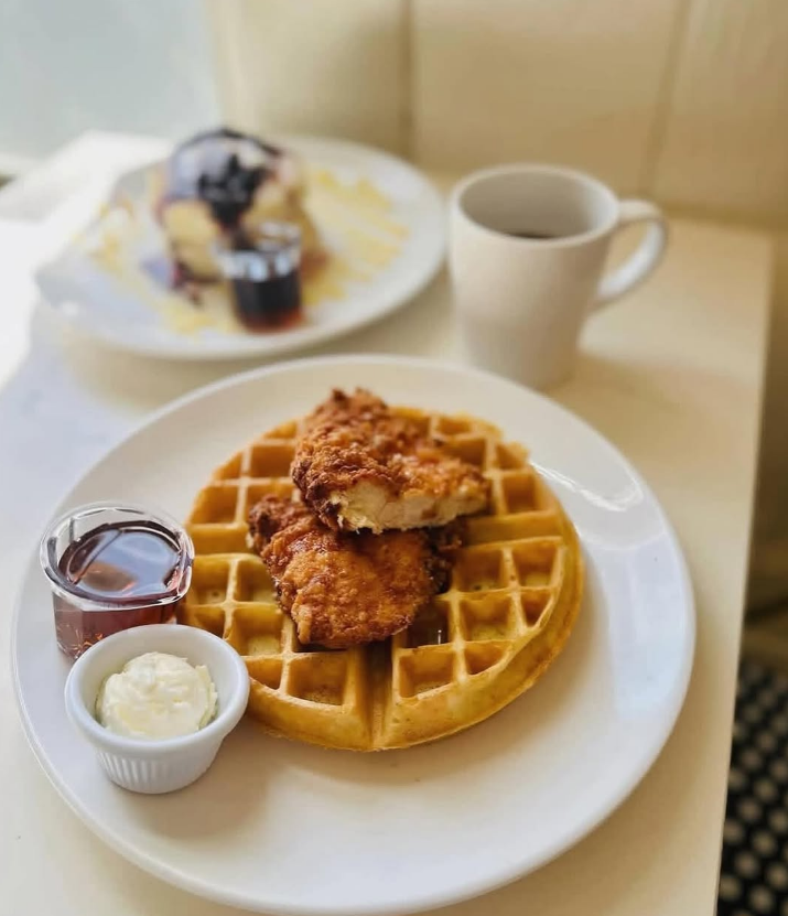 Chicken and waffles with warm syrup and coffee