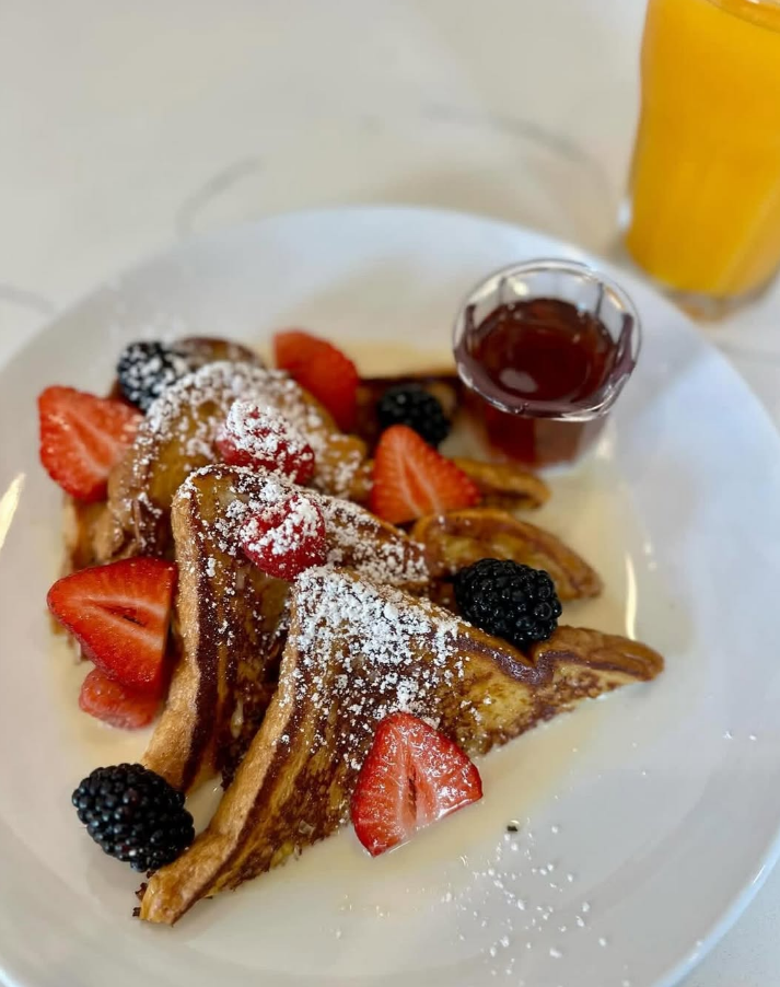 Brioche French toast with berries and fresh orange juice