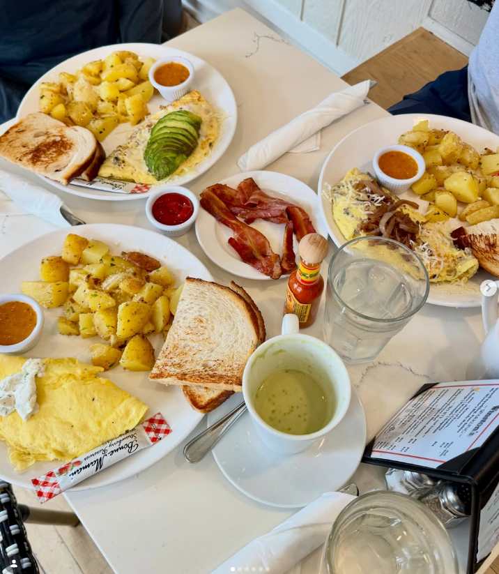 A full brunch table set with omelets and coffee
